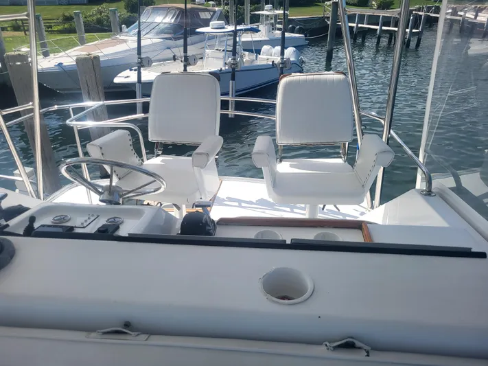 Hailey Girl Yacht Photos Pics Cockpit of 1989 Ocean Yachts 48 with white captain chairs and steering wheel.
