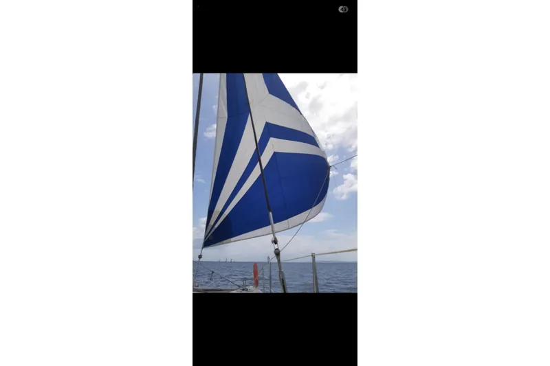 Ocean Mandalay Yacht Photos Pics Sailing on a 2003 Fountaine Pajot Belize 43 with blue and white sails.