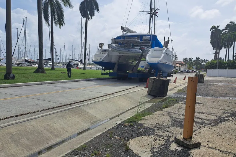 Ocean Mandalay Yacht Photos Pics 2003 Fountaine Pajot Belize 43 catamaran on trailer at marina with palm trees.