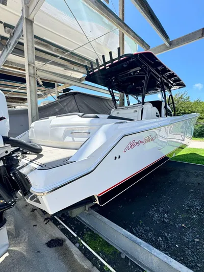  Yacht Photos Pics 2019 Nor-Tech 390 Sport Center Console boat in storage, sleek design, white exterior.