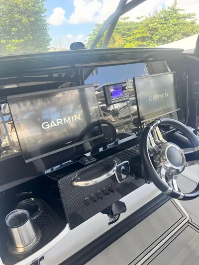 Yacht Photos Pics 2019 Nor-Tech 390 Sport Center Console helm with Garmin displays and steering wheel.