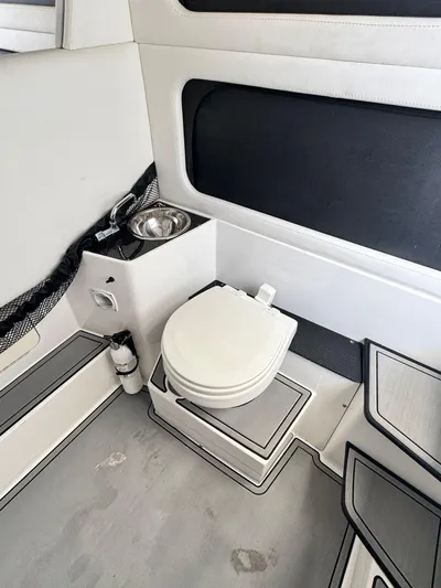 Yacht Photos Pics 2019 Nor-Tech 390 Sport Center Console boat interior with toilet and sink.