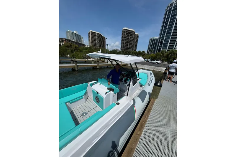  Yacht Photos Pics 2026 Ranieri CAYMAN 27.0 SPORT TOURING boat docked near modern high-rise buildings.