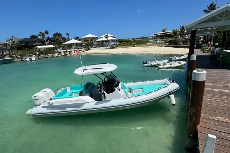  Yacht Photos Pics 2026 Ranieri CAYMAN 27.0 SPORT TOURING boat docked in clear turquoise water.