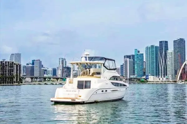 Bella Vita Yacht Photos Pics 2007 Meridian 459 Motoryacht cruising near city skyline on calm waters.