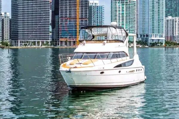 Bella Vita Yacht Photos Pics 2007 Meridian 459 Motoryacht on water with city skyline backdrop.