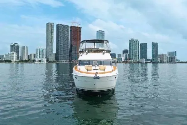 Bella Vita Yacht Photos Pics 2007 Meridian 459 Motoryacht on water with city skyline backdrop.