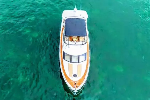 Bella Vita Yacht Photos Pics Overhead view of 2007 Meridian 459 Motoryacht on clear turquoise water.