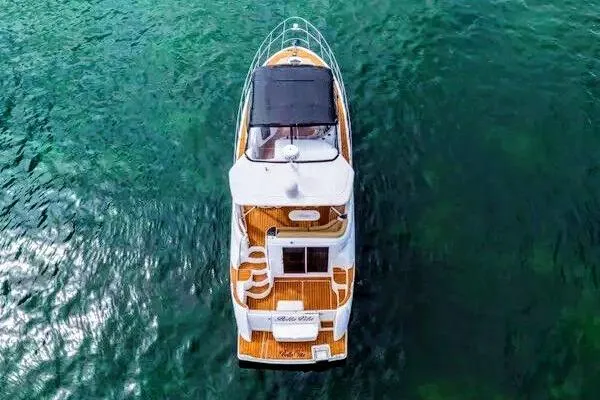 Bella Vita Yacht Photos Pics 2007 Meridian 459 Motoryacht on clear water, aerial view.