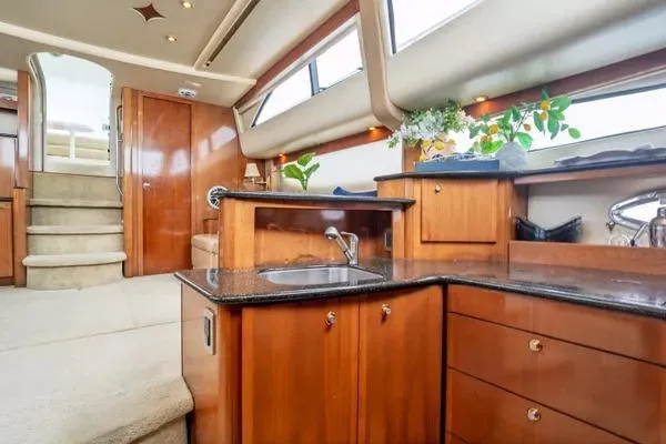 Bella Vita Yacht Photos Pics Luxurious interior of 2007 Meridian 459 Motoryacht with elegant wood cabinetry and modern amenities.