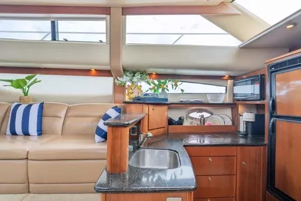 Bella Vita Yacht Photos Pics Luxurious interior of 2007 Meridian 459 Motoryacht with modern kitchen and comfortable seating.