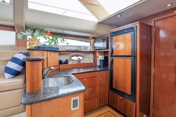 Bella Vita Yacht Photos Pics Luxurious kitchen interior of 2007 Meridian 459 Motoryacht with wood cabinetry and modern appliances.