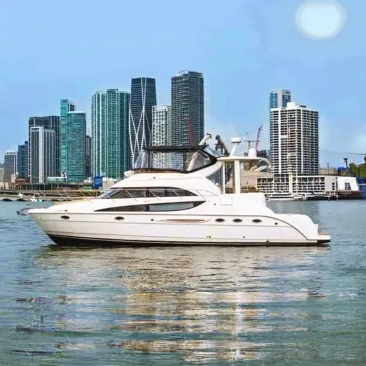 Bella Vita Yacht Photos Pics 2007 Meridian 459 Motoryacht cruising near city skyline.