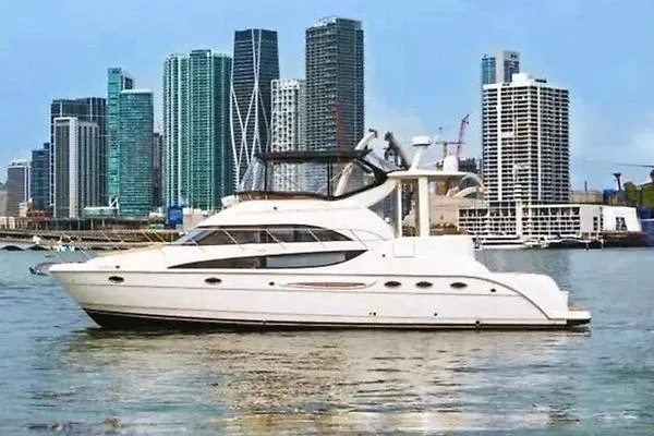 Bella Vita Yacht Photos Pics 2007 Meridian 459 Motoryacht cruising near a city skyline with modern skyscrapers.