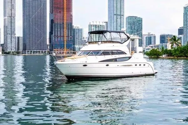 Bella Vita Yacht Photos Pics 2007 Meridian 459 Motoryacht on water with city skyline backdrop.