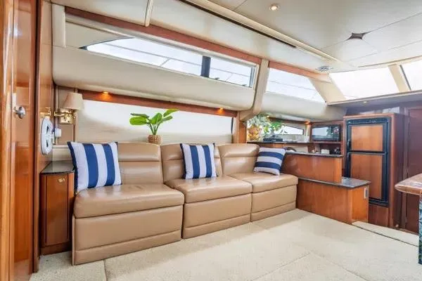 Bella Vita Yacht Photos Pics Luxurious interior of 2007 Meridian 459 Motoryacht with leather seating and striped cushions.