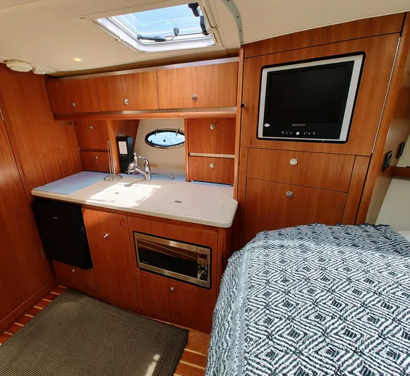 St Mary Yacht Photos Pics Interior of 2008 Tiara Yachts 3200 Open, featuring kitchenette and cozy cabin space.