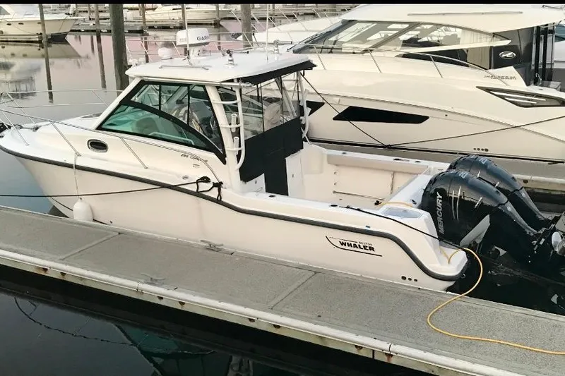  Yacht Photos Pics 2016 Boston Whaler 285 Conquest boat docked at marina with twin Mercury engines.