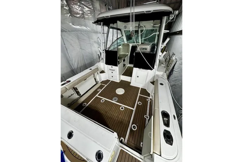  Yacht Photos Pics 2016 Boston Whaler 285 Conquest boat interior with wood deck and seating.
