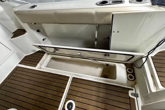  Yacht Photos Pics 2016 Boston Whaler 285 Conquest boat deck with open storage compartment.