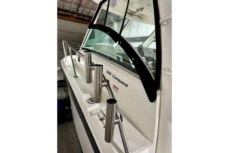  Yacht Photos Pics 2016 Boston Whaler 285 Conquest boat with stainless steel rod holders and windshield.