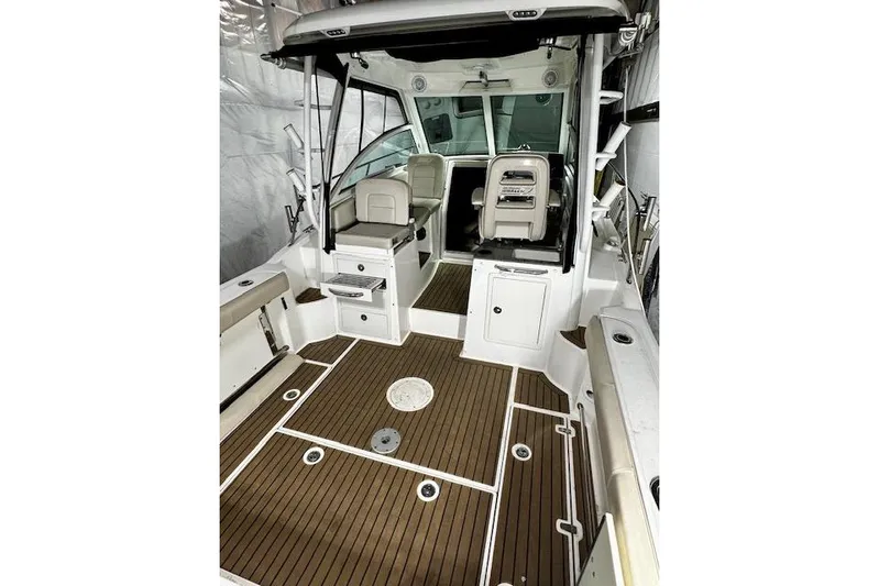  Yacht Photos Pics 2016 Boston Whaler 285 Conquest boat interior with wood flooring and seating.