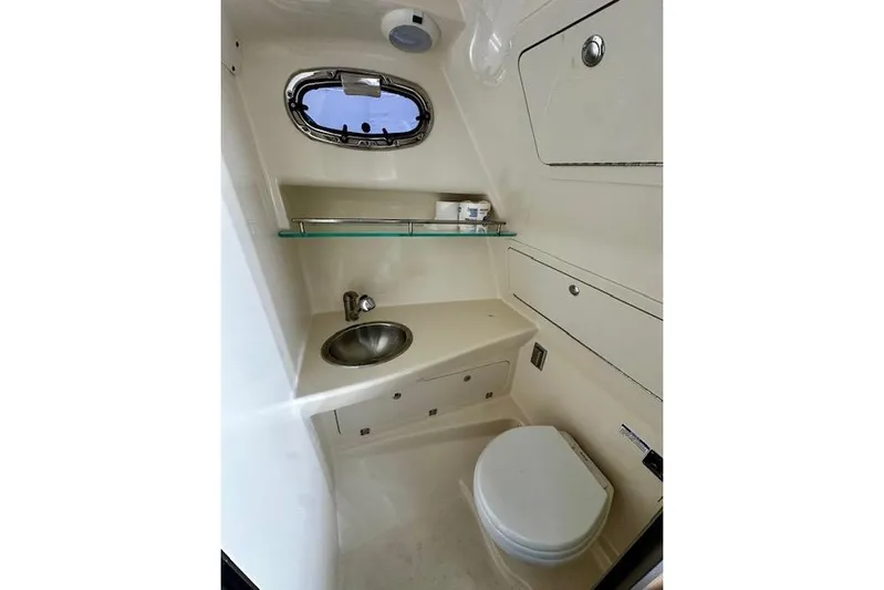  Yacht Photos Pics 2016 Boston Whaler 285 Conquest boat bathroom with sink, toilet, and storage.