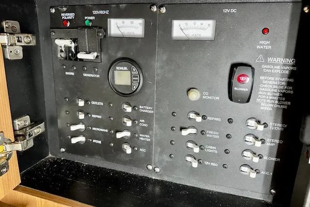  Yacht Photos Pics Control panel of a 2016 Boston Whaler 285 Conquest boat, featuring various switches and gauges.