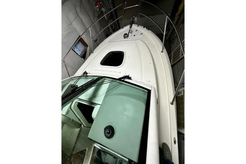  Yacht Photos Pics 2016 Boston Whaler 285 Conquest boat in storage, showcasing deck and cabin features.