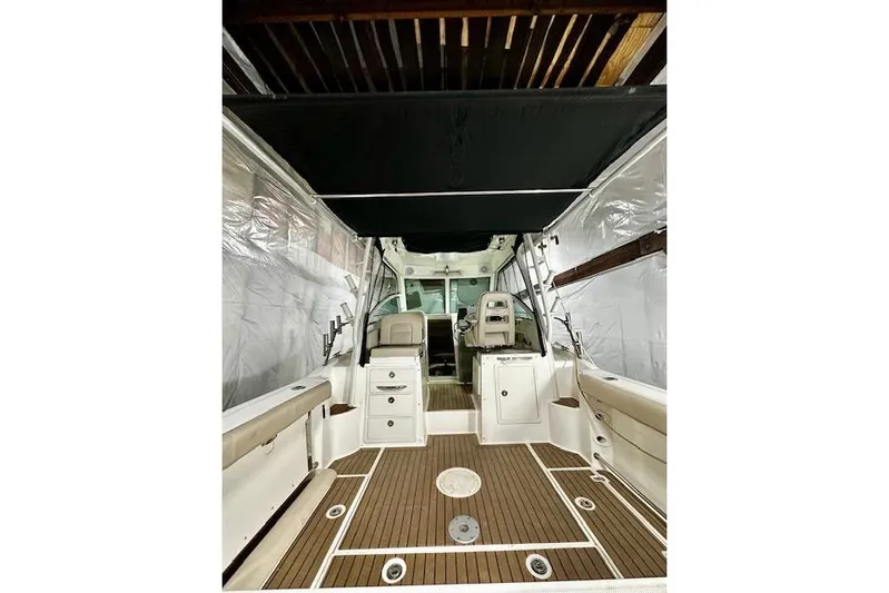  Yacht Photos Pics 2016 Boston Whaler 285 Conquest boat interior with seating and wood flooring.