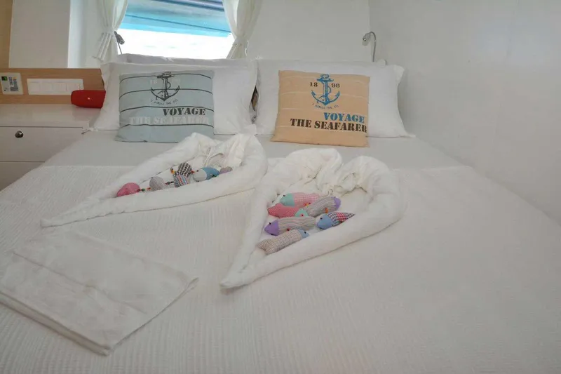  Yacht Photos Pics Cozy cabin bed with nautical-themed pillows and towel art on a 2017 Custom GULET.