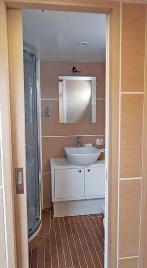  Yacht Photos Pics Modern bathroom on 2017 Custom GULET yacht with sleek fixtures and wood accents.