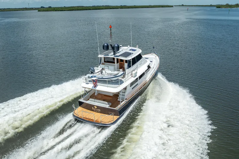 Escape Yacht Photos Pics 2022 Grand Banks GB60 Skylounge yacht cruising on open water.