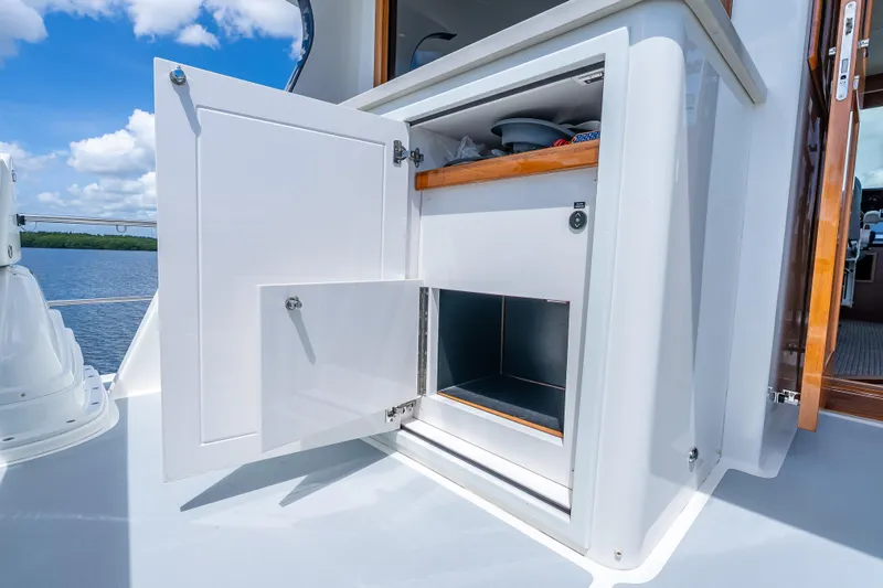 Escape Yacht Photos Pics Open storage compartment on 2022 Grand Banks GB60 Skylounge yacht deck.