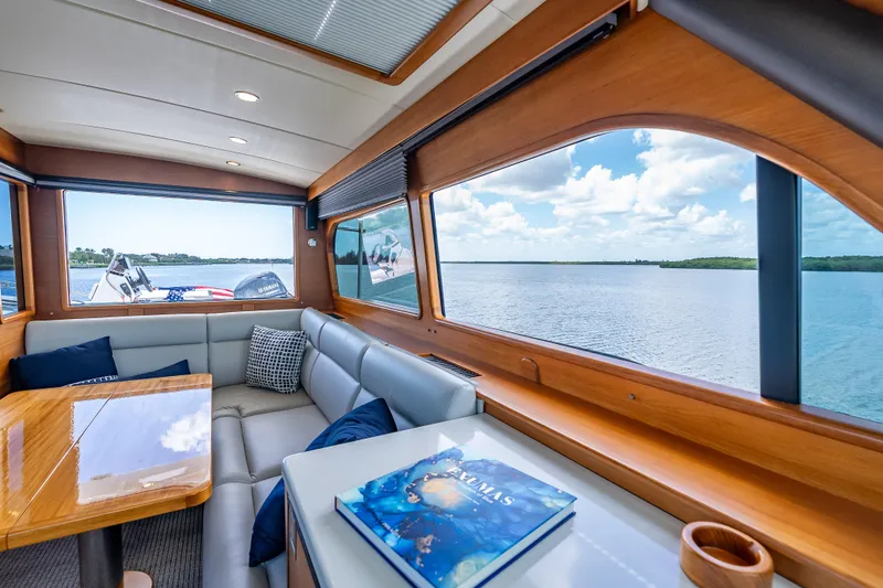 Escape Yacht Photos Pics Luxurious interior of 2022 Grand Banks GB60 Skylounge yacht with scenic water views.