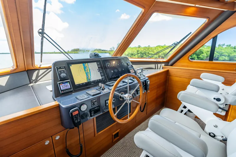Escape Yacht Photos Pics 2022 Grand Banks GB60 Skylounge helm with modern navigation equipment and luxurious seating.