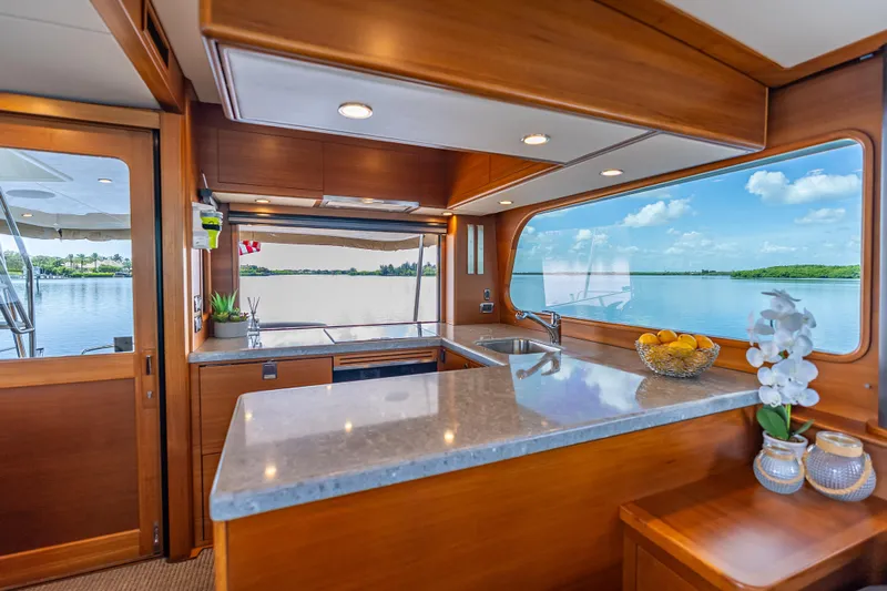 Escape Yacht Photos Pics Luxurious 2022 Grand Banks GB60 Skylounge interior with scenic water view.