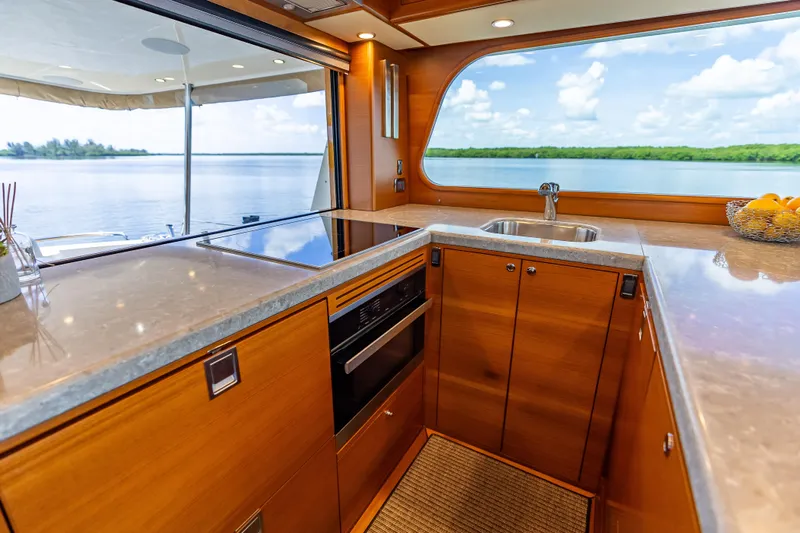 Escape Yacht Photos Pics Luxurious 2022 Grand Banks GB60 Skylounge kitchen with scenic ocean view.