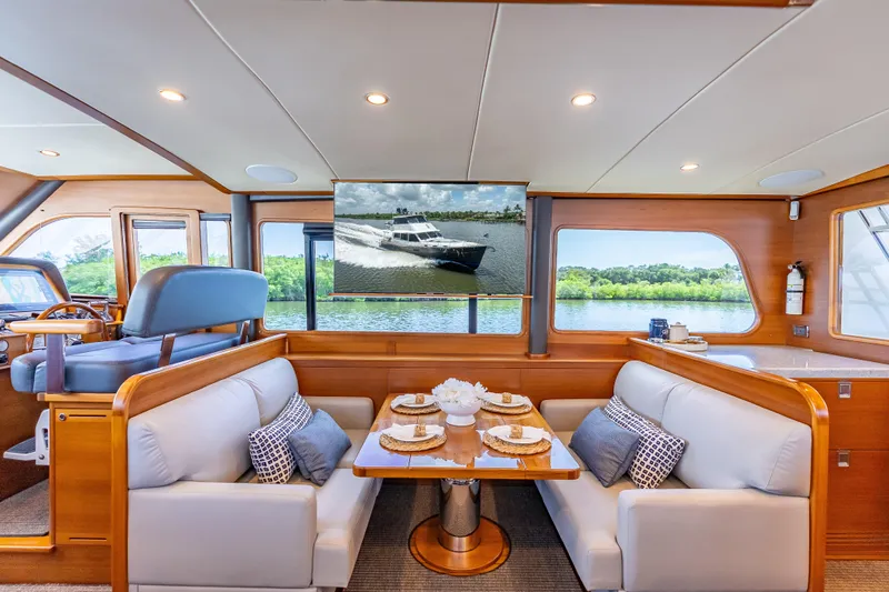 Escape Yacht Photos Pics Luxurious interior of 2022 Grand Banks GB60 Skylounge yacht with elegant dining area.