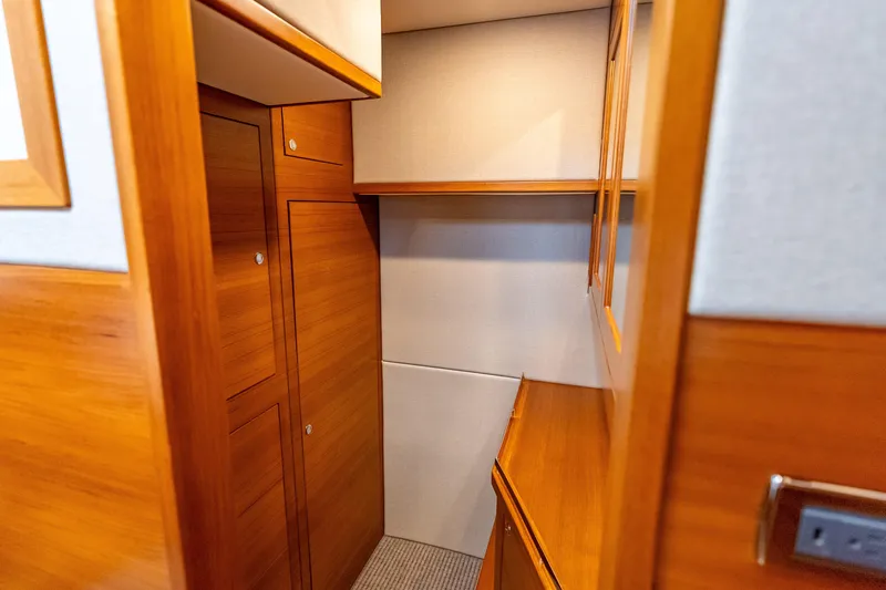 Escape Yacht Photos Pics 2022 Grand Banks GB60 Skylounge interior with wooden cabinetry and modern design.