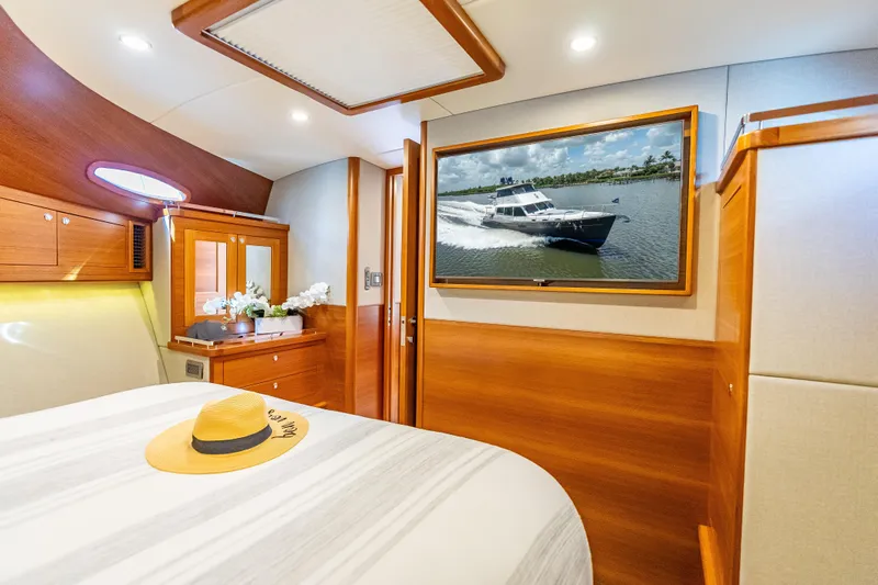 Escape Yacht Photos Pics Luxurious 2022 Grand Banks GB60 Skylounge cabin with elegant wood finishes and modern decor.