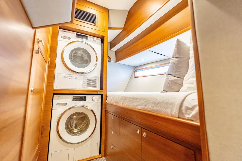 Escape Yacht Photos Pics Laundry area and cozy cabin in 2022 Grand Banks GB60 Skylounge yacht.