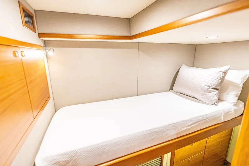Escape Yacht Photos Pics 2022 Grand Banks GB60 Skylounge cabin with single bed and wooden cabinetry.