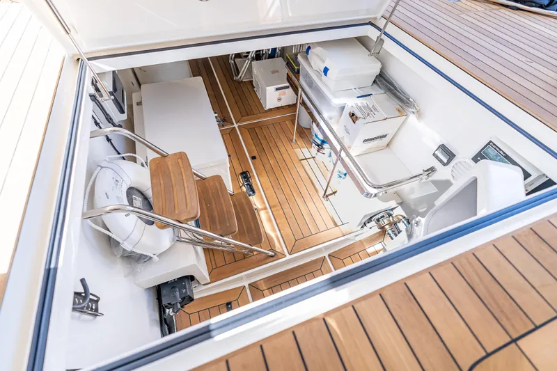 Escape Yacht Photos Pics Engine room of 2022 Grand Banks GB60 Skylounge with teak flooring and equipment.