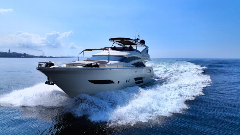 Dolly Yacht Photos Pics Luxurious 2015 Dominator 800 yacht cruising on open water under clear blue skies.
