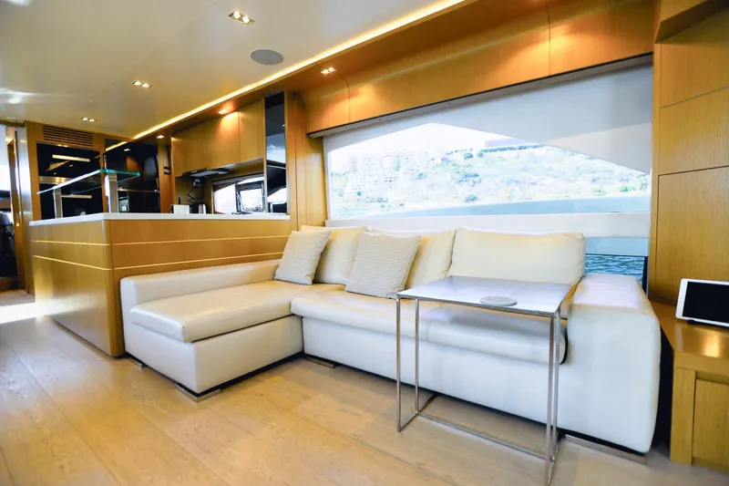 Dolly Yacht Photos Pics Luxurious interior of 2015 Dominator 800 yacht with modern white sofa and wooden accents.