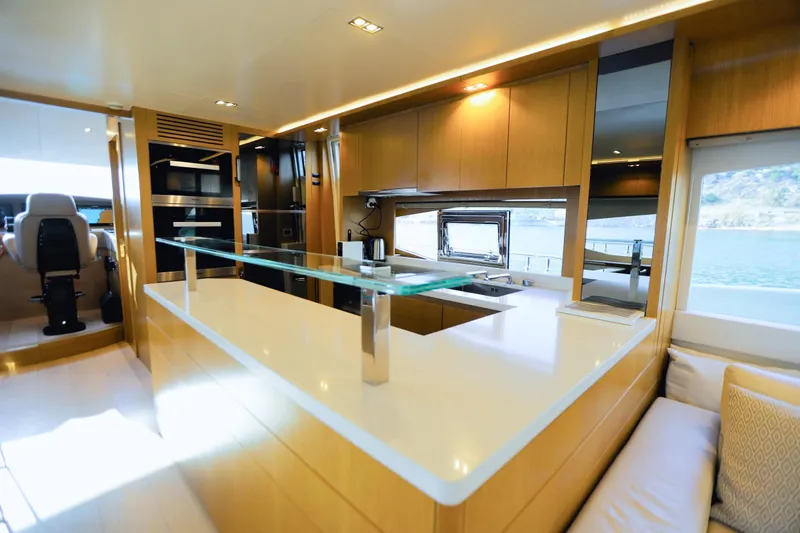 Dolly Yacht Photos Pics Luxurious interior of 2015 Dominator 800 yacht with modern kitchen and seating area.