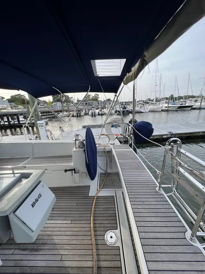 Serendipity Yacht Photos Pics 2013 Beneteau Oceanis 45 sailboat docked at marina, featuring spacious deck and canopy.