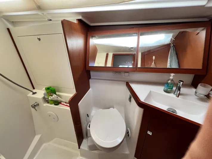 Serendipity Yacht Photos Pics Bathroom interior of 2013 Beneteau Oceanis 45 yacht, featuring toilet, sink, and mirror.