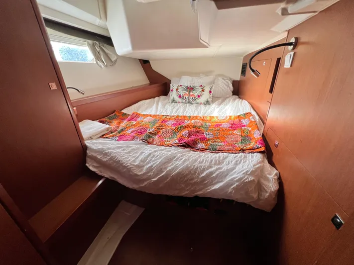 Serendipity Yacht Photos Pics Cozy cabin interior of 2013 Beneteau Oceanis 45 with colorful bedding and wooden finish.